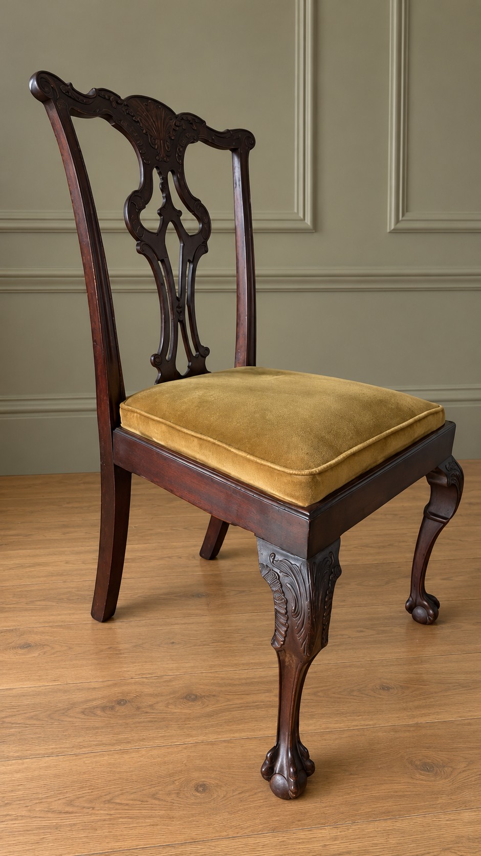 A set of four mahogany Chippendale style dining chairs featuring carved pierced splats, gold-coloured velvet seats, and cabriole front legs with ball-and-claw feet. View VI