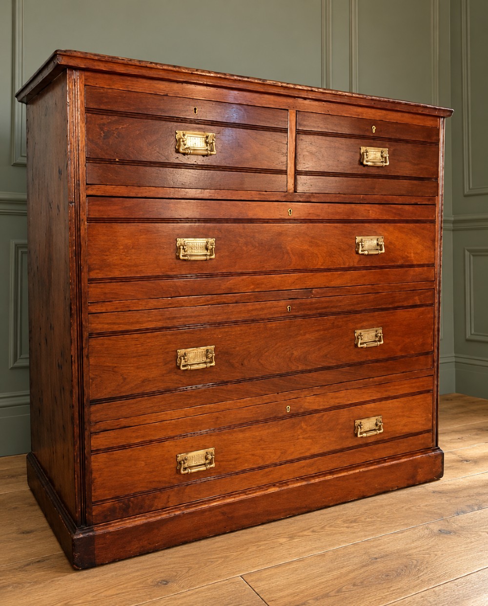 A Victorian warm brown walnut chest of drawers featuring a two-over-three drawer arrangement, reeded moulding, and fitted brass handles. View II