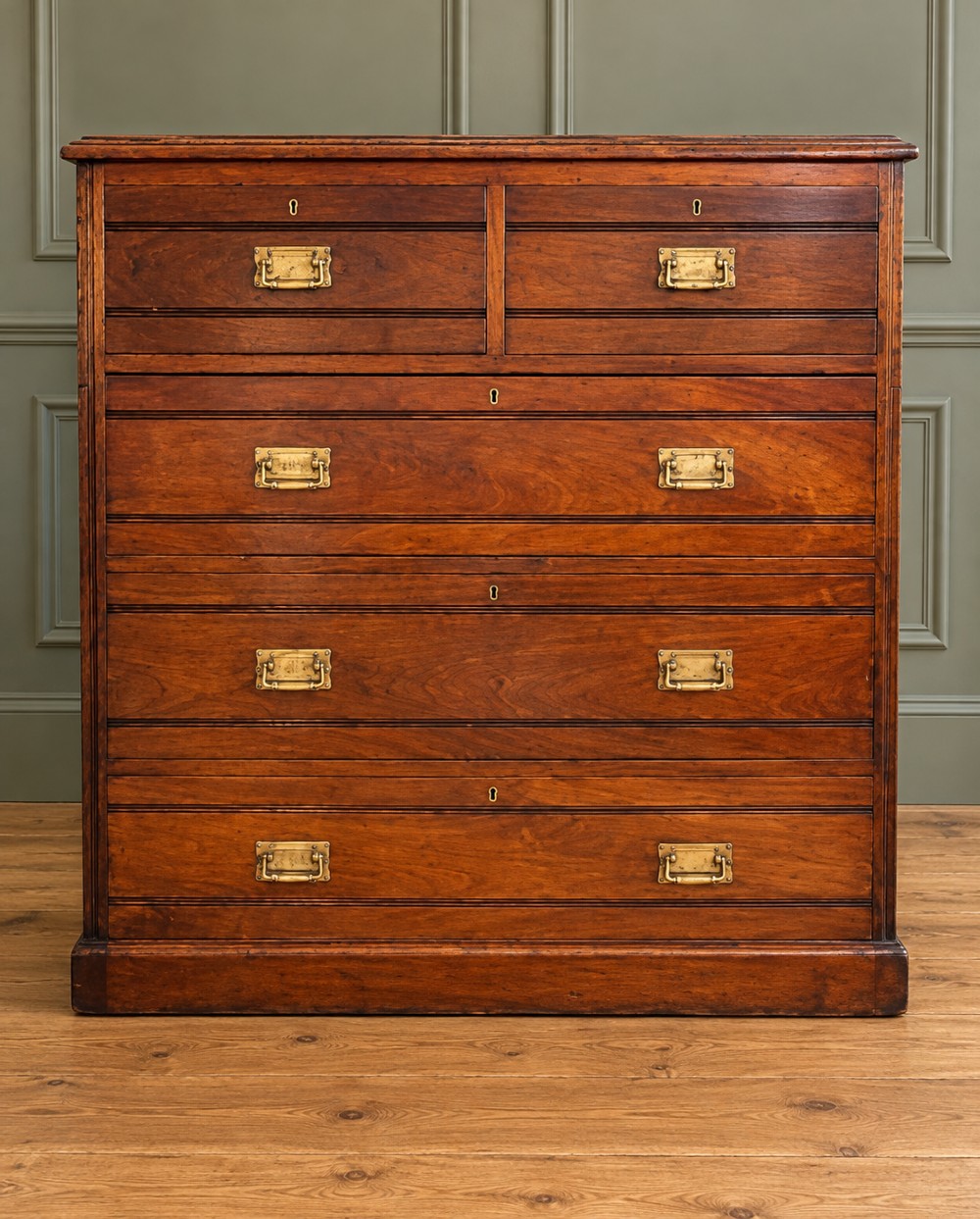 A Victorian warm brown walnut chest of drawers featuring a two-over-three drawer arrangement, reeded moulding, and fitted brass handles. View IV