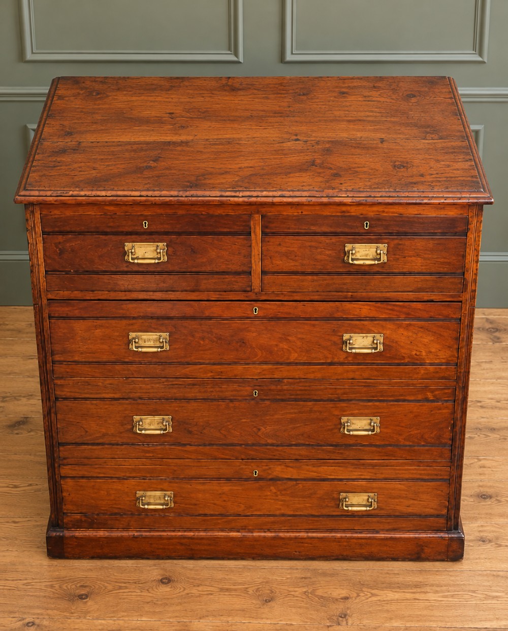 A Victorian warm brown walnut chest of drawers featuring a two-over-three drawer arrangement, reeded moulding, and fitted brass handles. View V