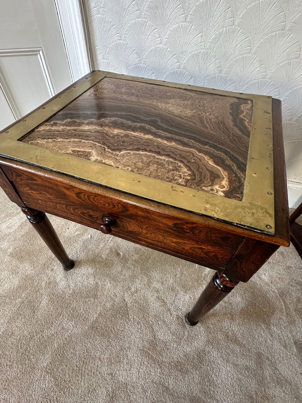 A dark brown Victorian wooden side table with turned legs, a single drawer, and an inset brown marble top with a brass frame. View II