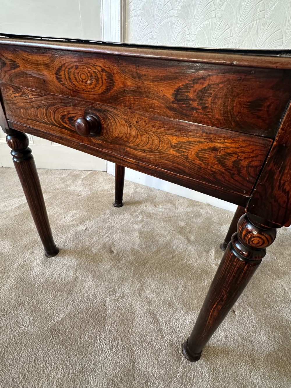 A dark brown Victorian wooden side table with turned legs, a single drawer, and an inset brown marble top with a brass frame. View IV