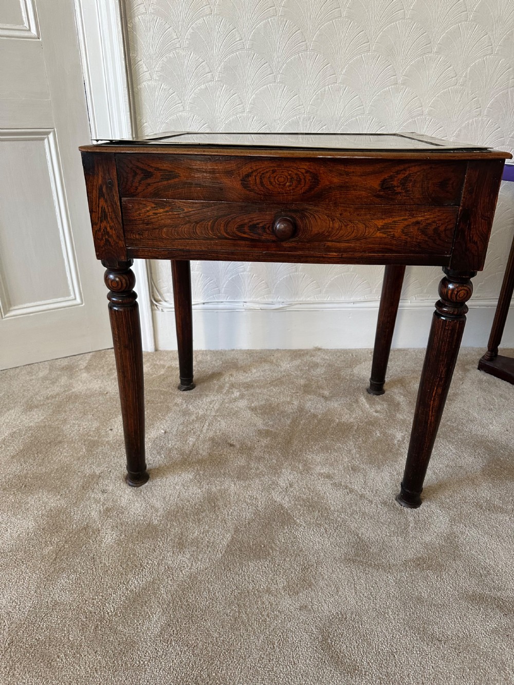 A dark brown Victorian wooden side table with turned legs, a single drawer, and an inset brown marble top with a brass frame. View VI