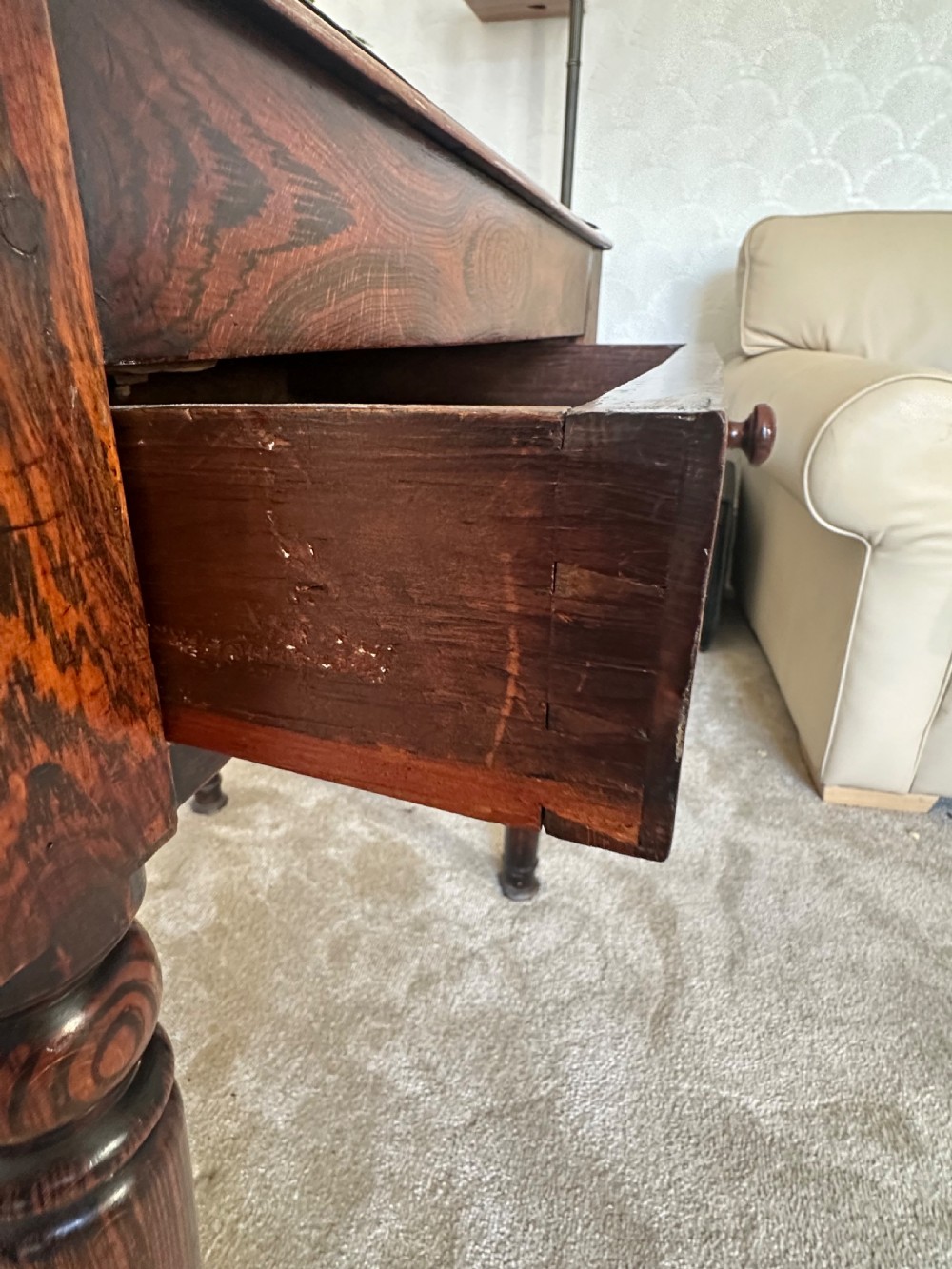 A dark brown Victorian wooden side table with turned legs, a single drawer, and an inset brown marble top with a brass frame. View VII