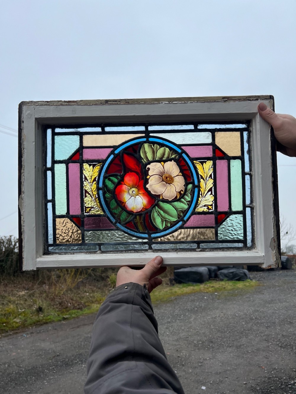 A fantastic stained glass window with painted flowers