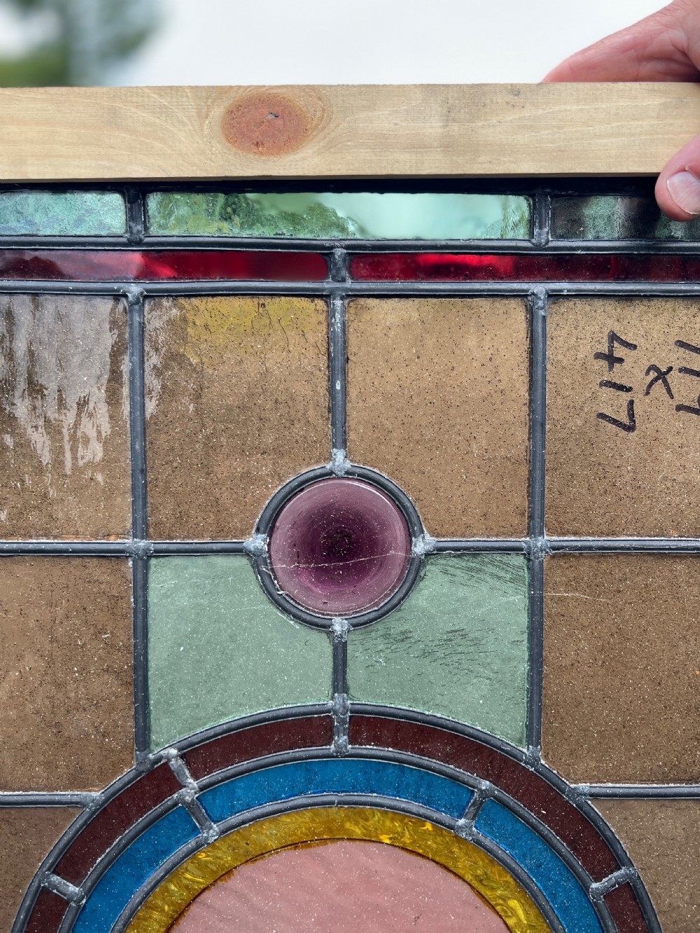 A rectangular Victorian leaded glass window panel featuring a central hand-painted bird roundel framed by colourful geometric borders and circular bullseye glass accents. View IV