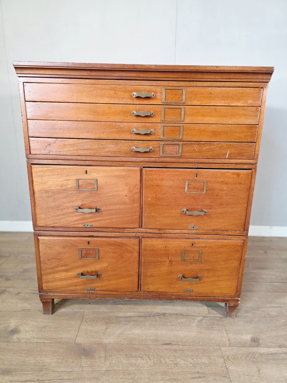 A vintage wooden sectional plan chest with multiple shallow and deep drawers fitted with brass pulls. View II