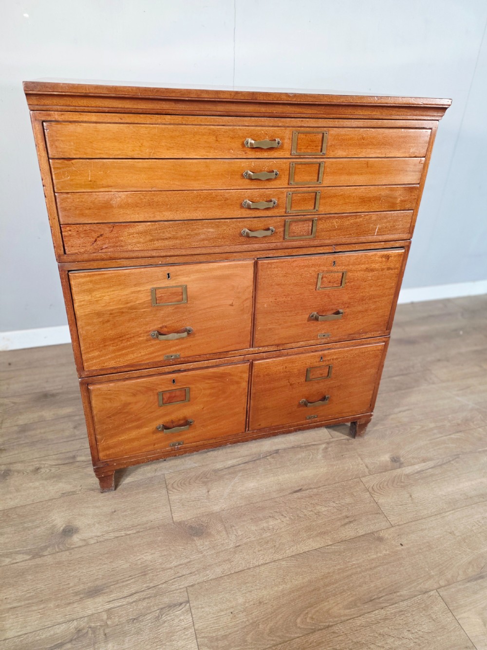 A vintage wooden sectional plan chest with multiple shallow and deep drawers fitted with brass pulls. View IV
