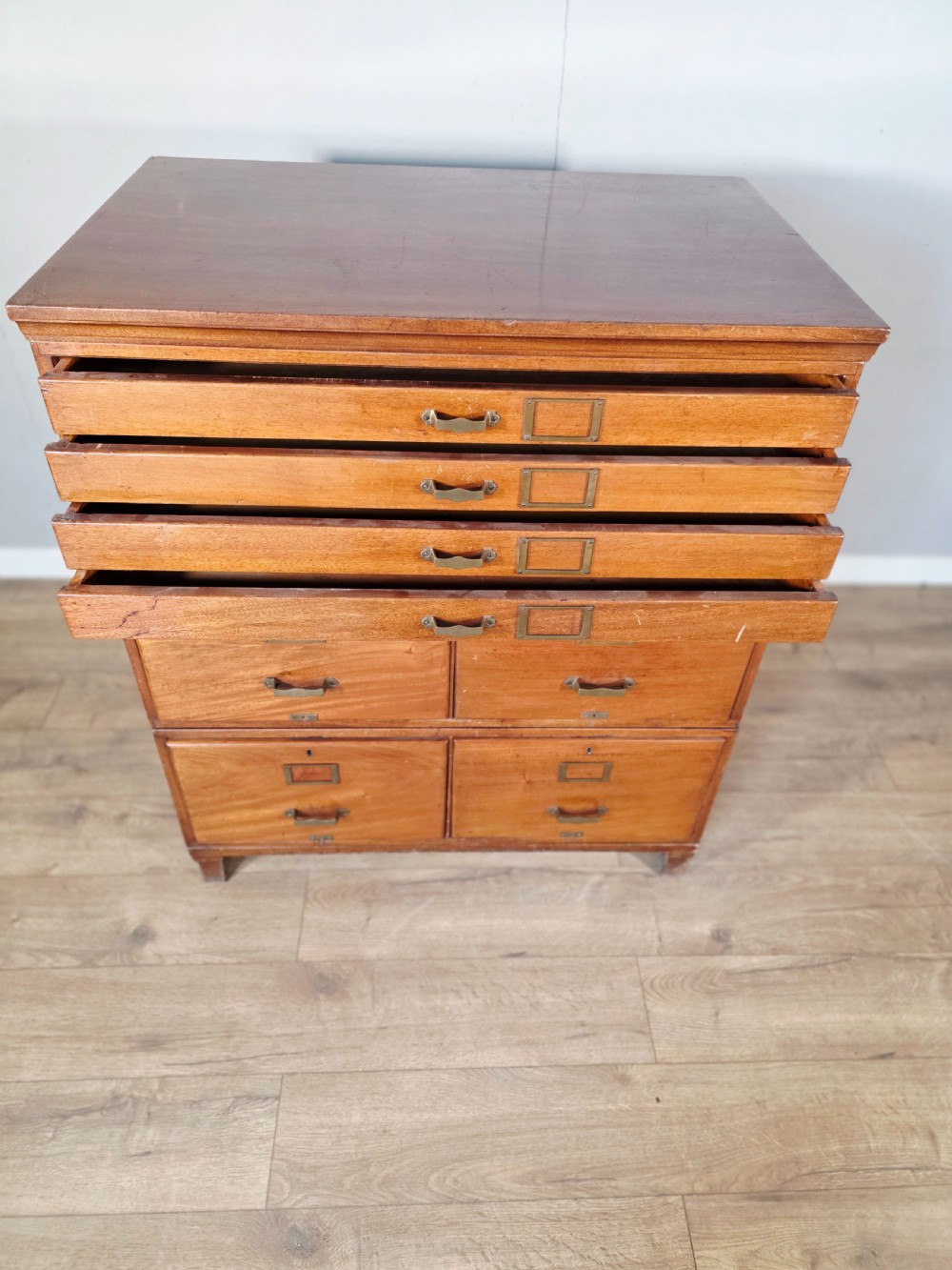 A vintage wooden sectional plan chest with multiple shallow and deep drawers fitted with brass pulls. View VI