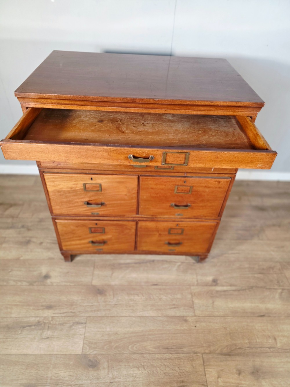 A vintage wooden sectional plan chest with multiple shallow and deep drawers fitted with brass pulls. View VII