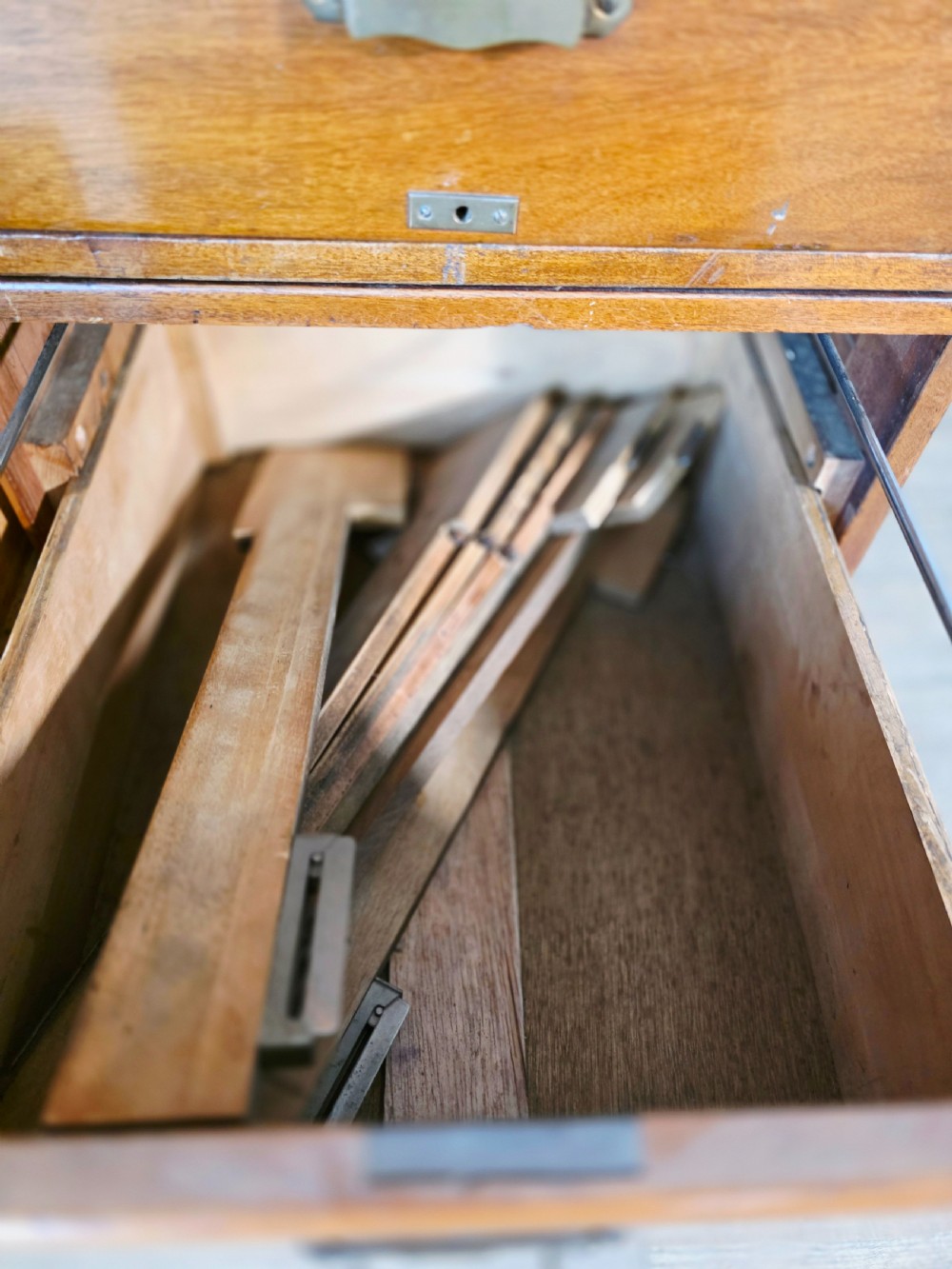 A vintage wooden sectional plan chest with multiple shallow and deep drawers fitted with brass pulls. View IX