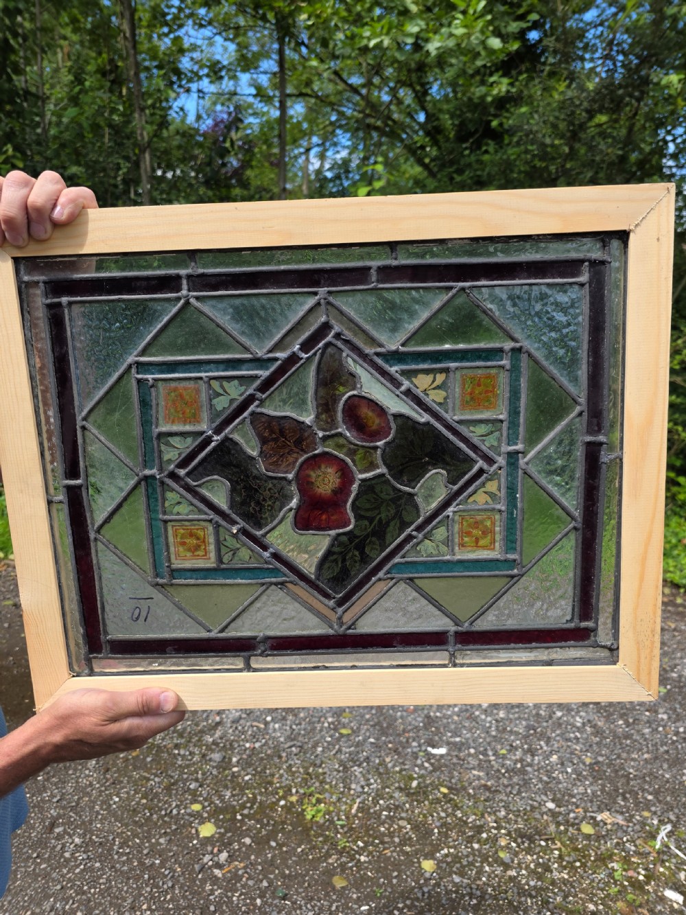 A rectangular late Victorian leaded glass window panel featuring central hand-painted floral motifs inside a geometric lead came frame with green and dark glass borders. View III
