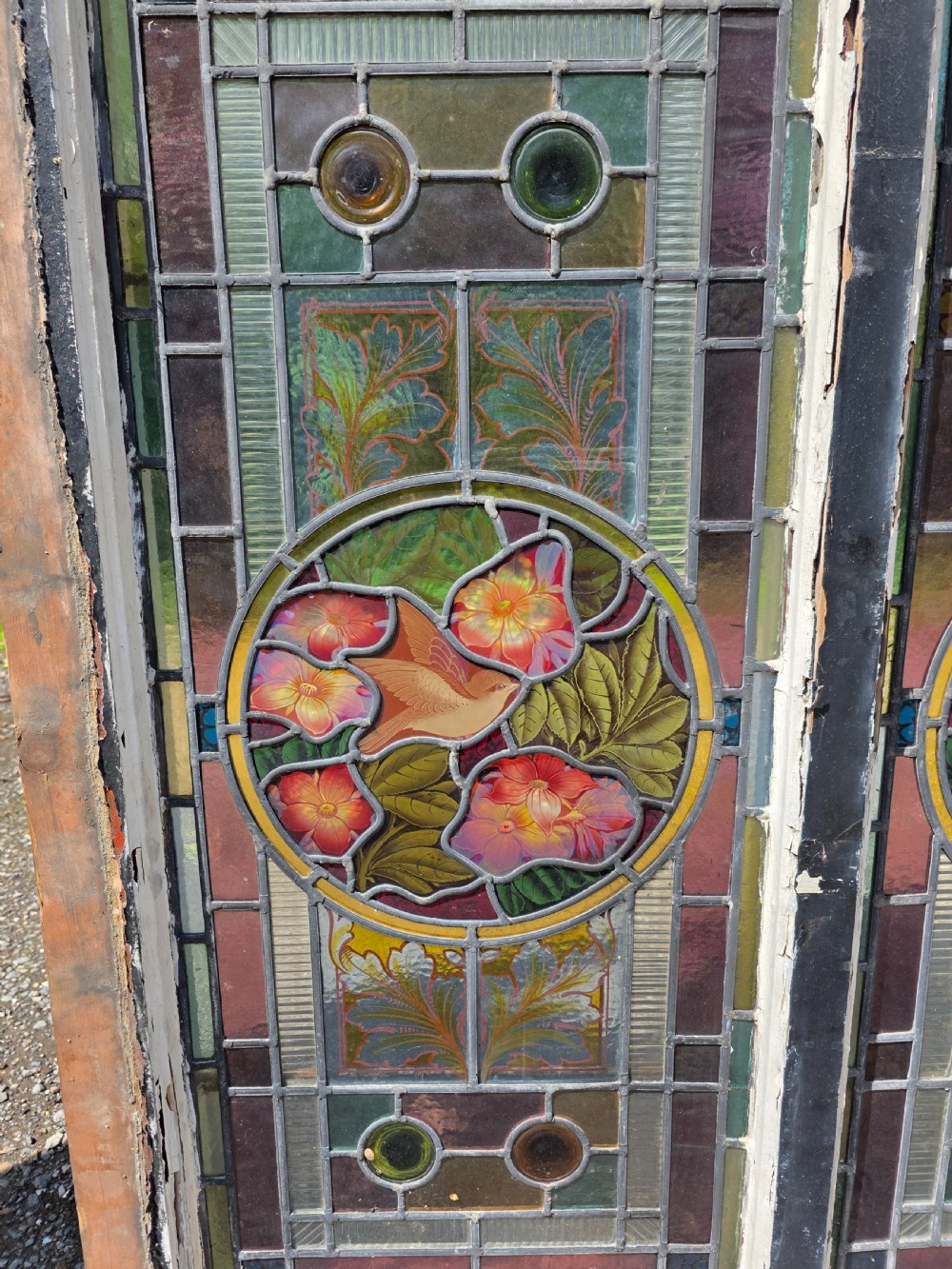 1880 antique leaded glass window with amber and green bullseyes and birds on flowers design  View II