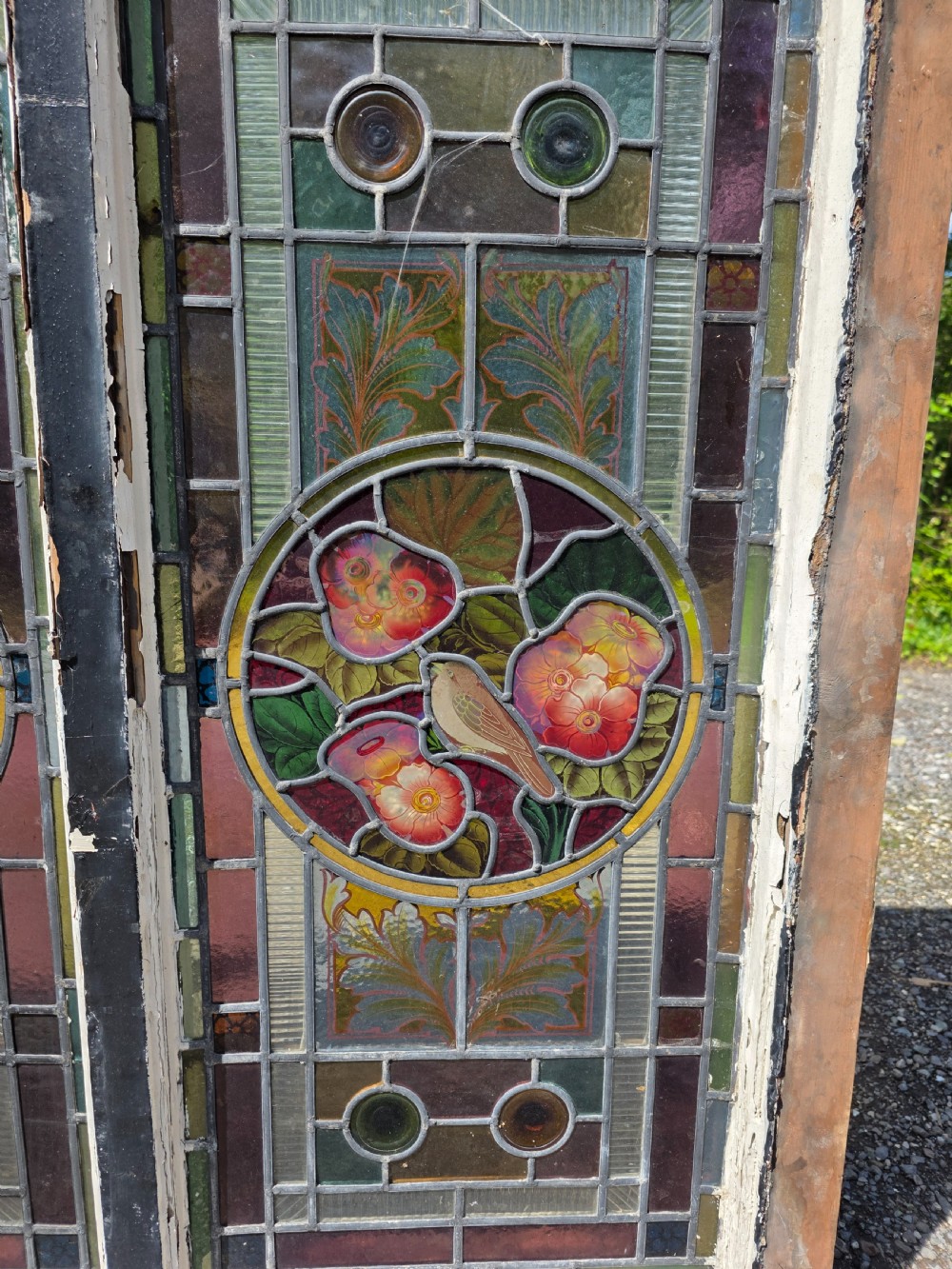 1880 antique leaded glass window with amber and green bullseyes and birds on flowers design  View III