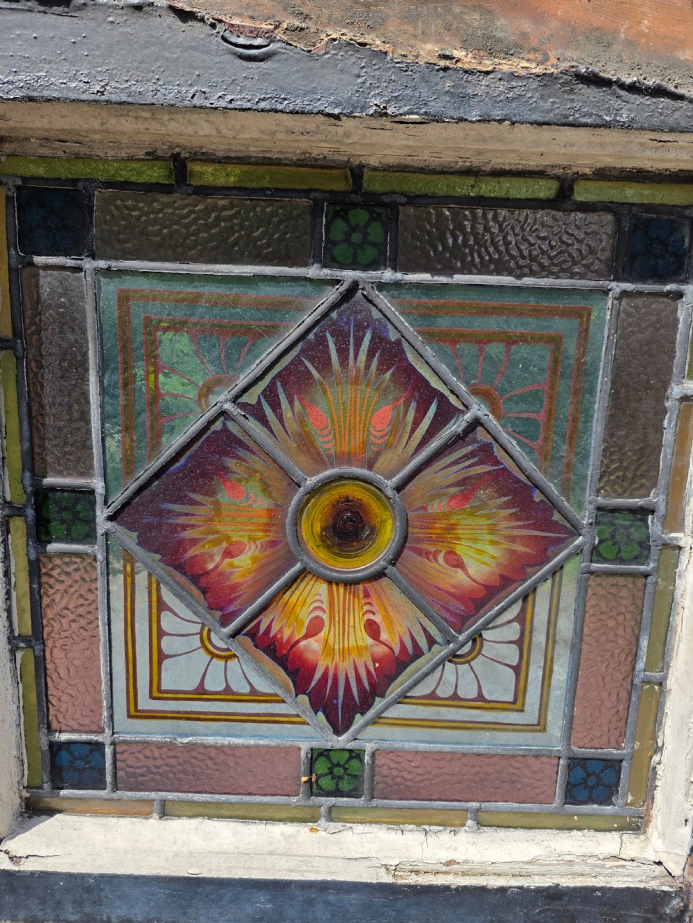 1880 antique leaded glass window with amber and green bullseyes and birds on flowers design  View V