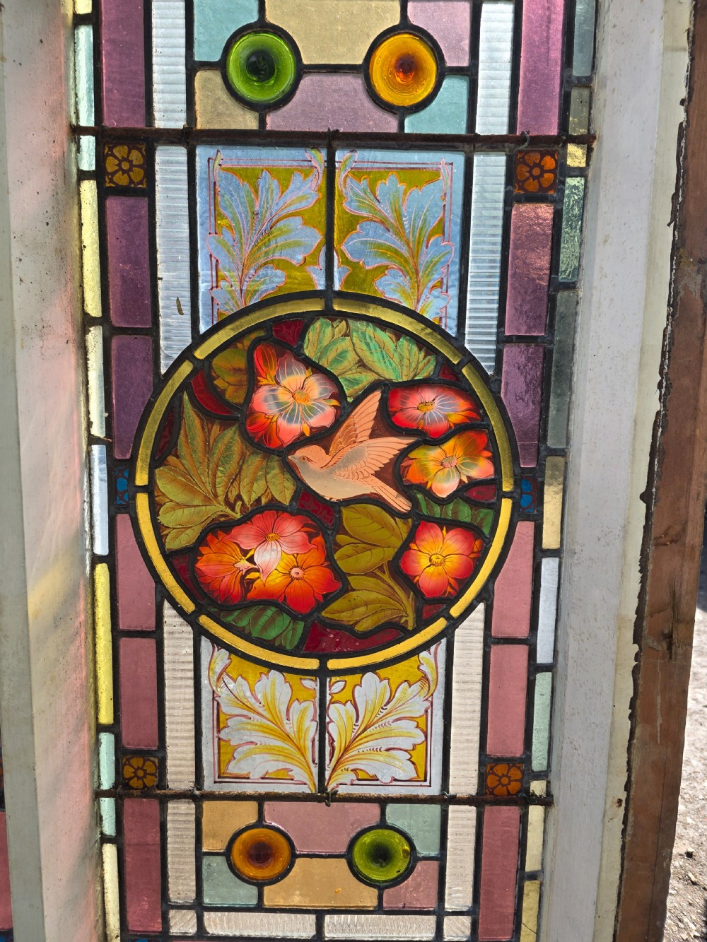 1880 antique leaded glass window with amber and green bullseyes and birds on flowers design  View VIII
