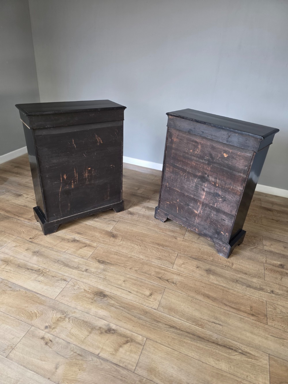 A pair of Victorian ebonised wooden pier cabinets featuring single glazed doors, gilt metal ormolu corner mounts, and oval porcelain plaques. View XVI
