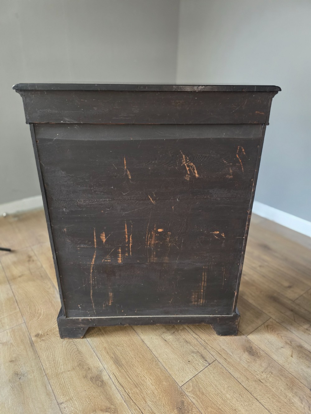 A pair of Victorian ebonised wooden pier cabinets featuring single glazed doors, gilt metal ormolu corner mounts, and oval porcelain plaques. View XVIII