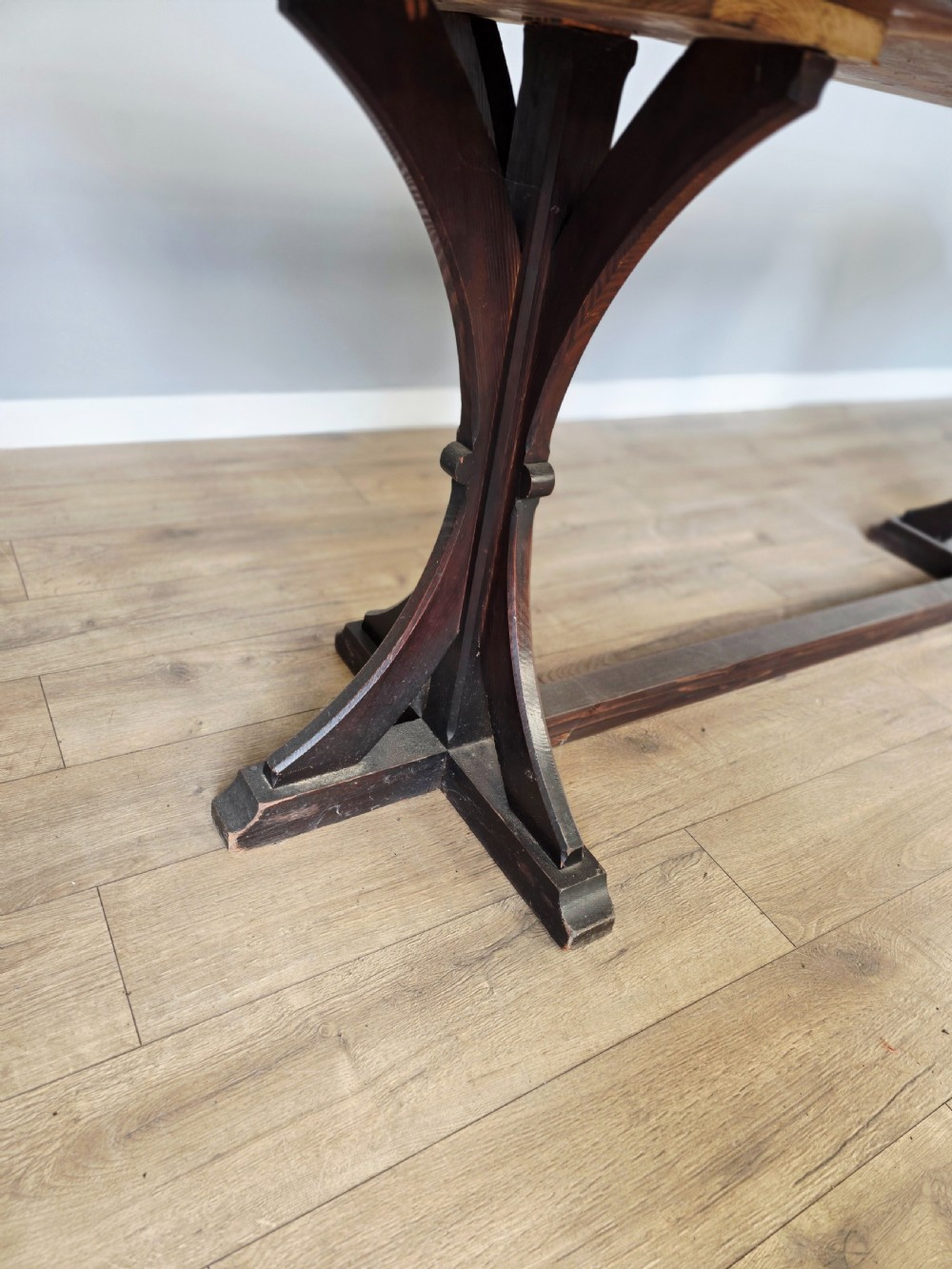 A long Victorian pitch pine centre serving table featuring a smooth rectangular top supported by curved trestle legs and a central stretcher base. View VIII