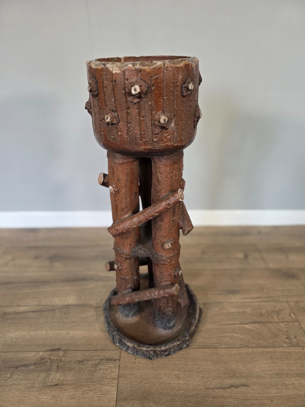 A 19th-century brown glazed ceramic jardiniere and stand textured to resemble tree bark and interlaced log branches. View II