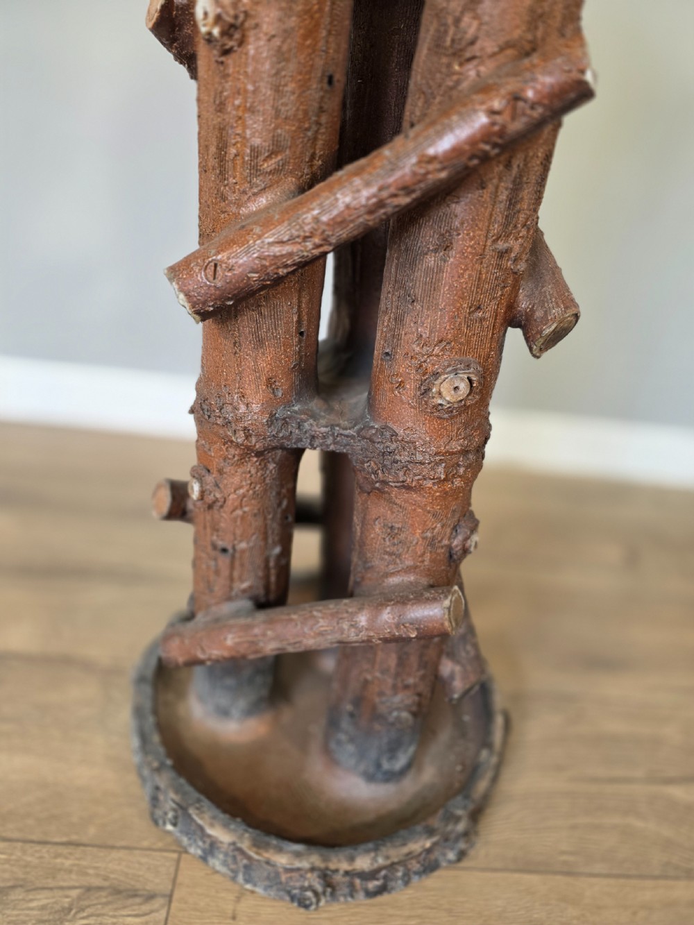 A 19th-century brown glazed ceramic jardiniere and stand textured to resemble tree bark and interlaced log branches. View V