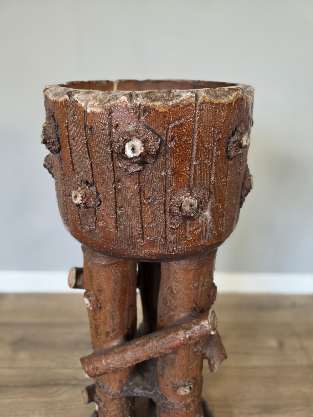 A 19th-century brown glazed ceramic jardiniere and stand textured to resemble tree bark and interlaced log branches. View VI