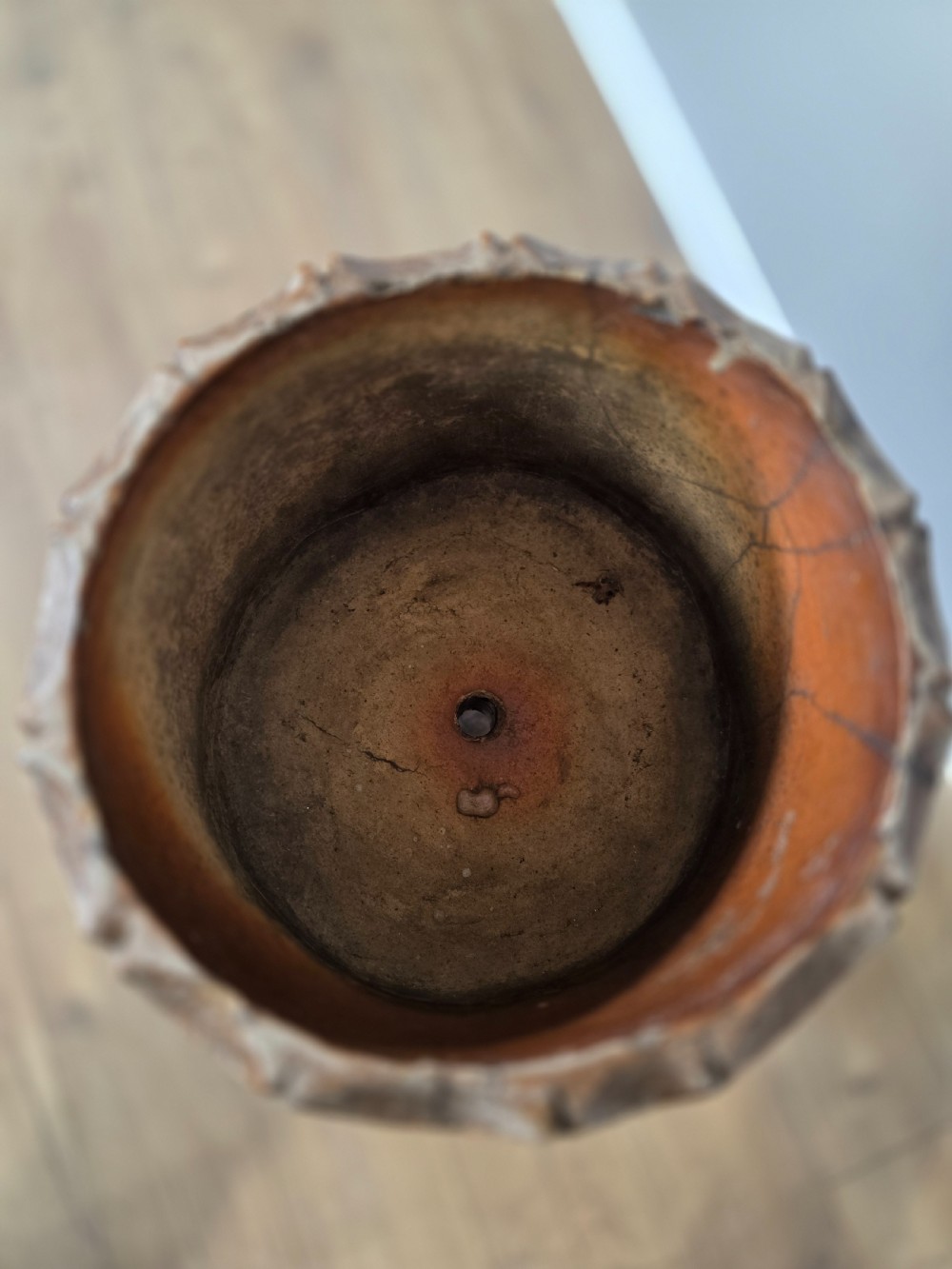 A 19th-century brown glazed ceramic jardiniere and stand textured to resemble tree bark and interlaced log branches. View X