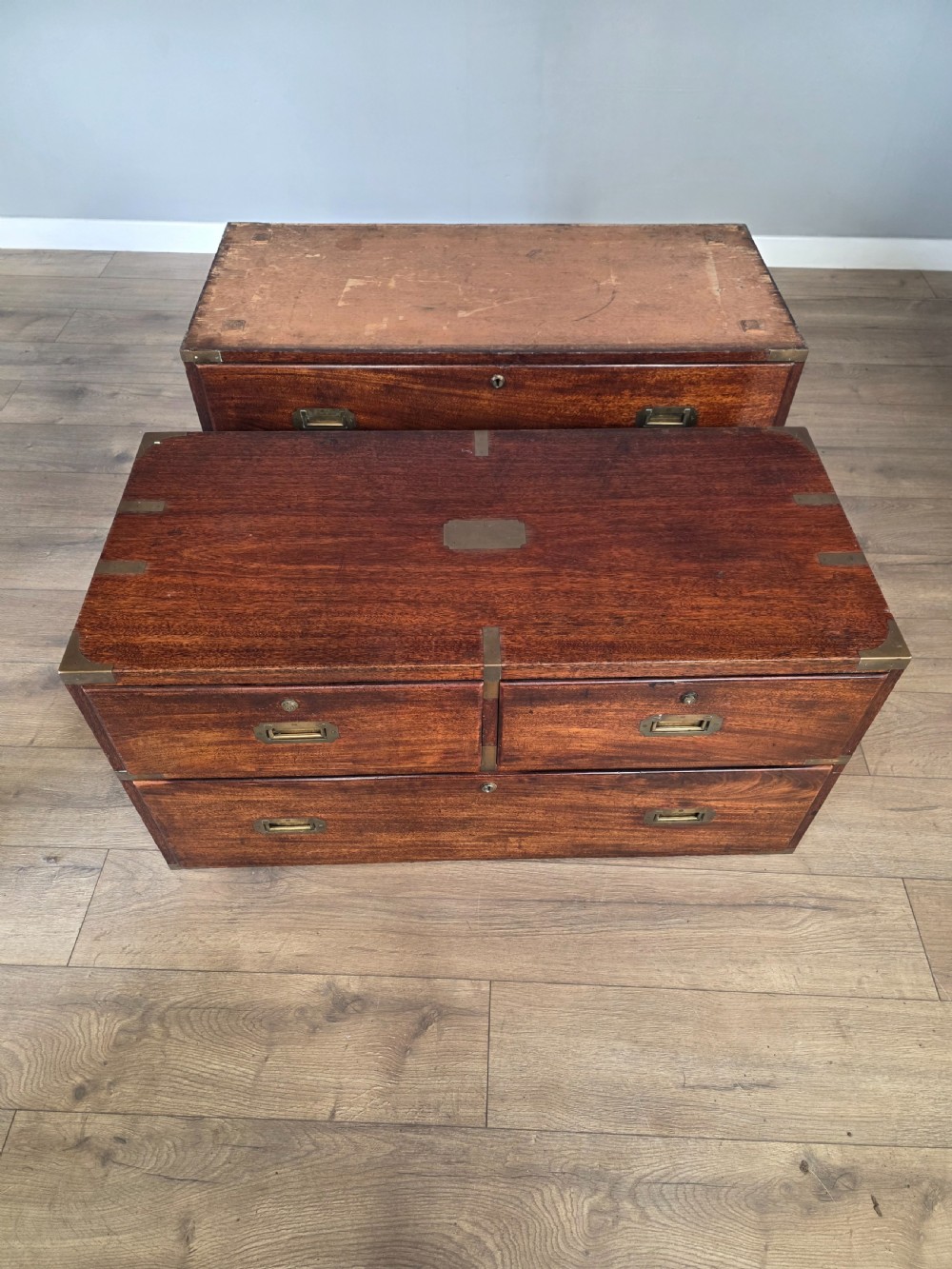 An 1830s Regency teak military campaign chest of drawers with flush brass corner brackets, strapwork, keyholes, and inset handles. View XIX