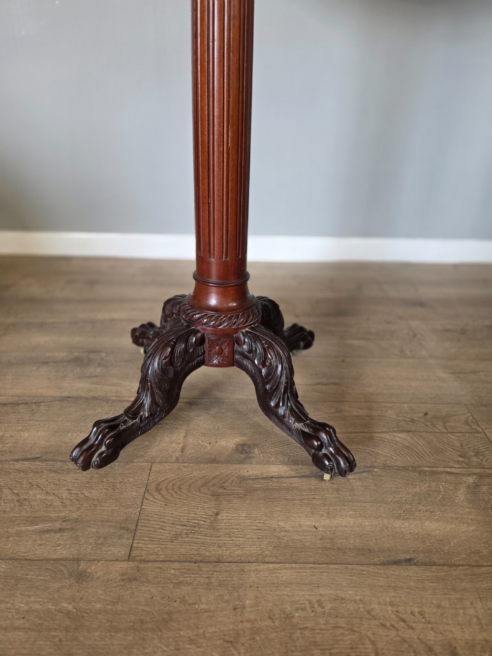 A tall mahogany gentlemans shaving stand featuring an adjustable rectangular mirror, a single drawer pedestal, a fluted column, and a carved tripod base. View III