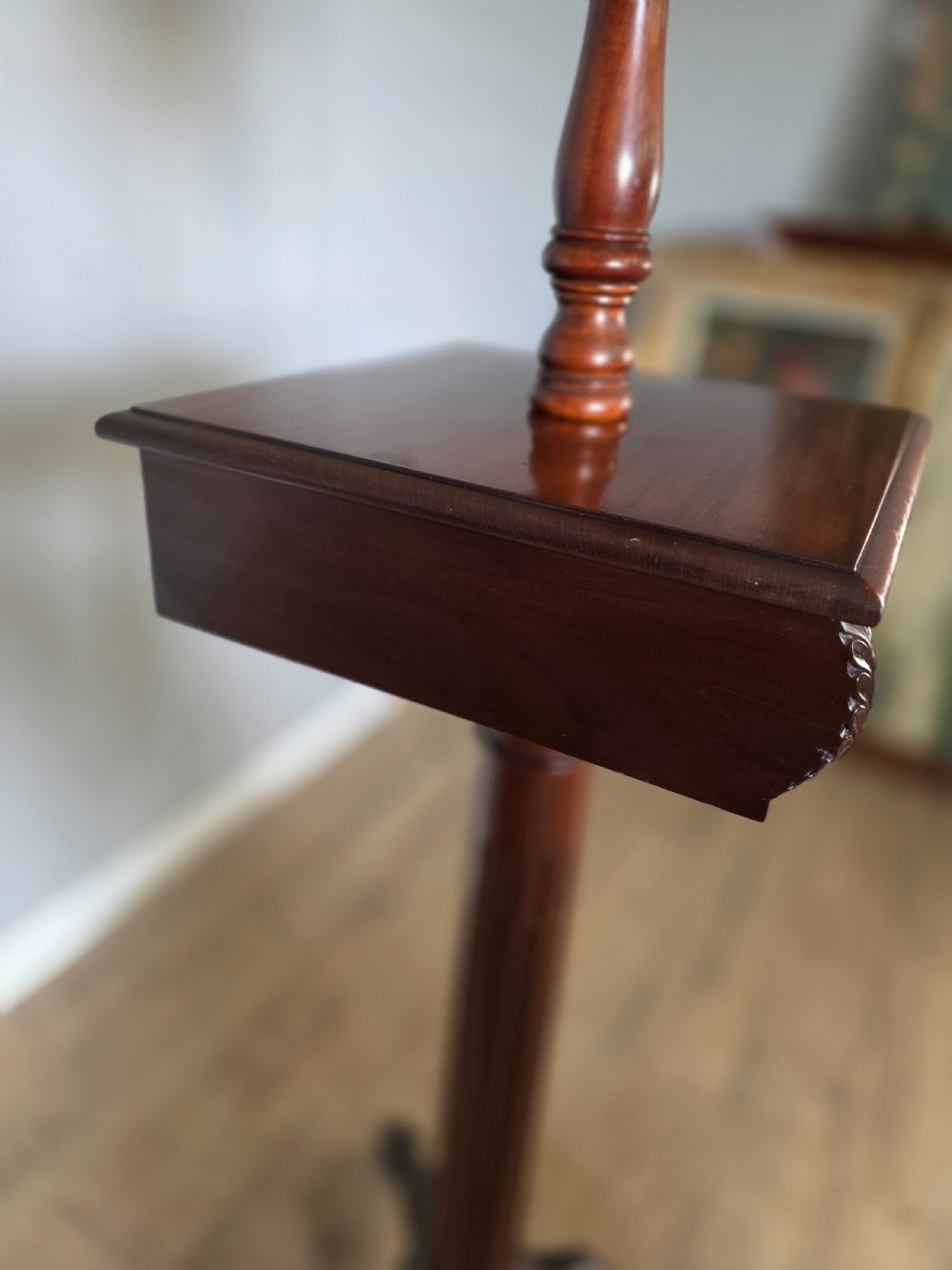 A tall mahogany gentlemans shaving stand featuring an adjustable rectangular mirror, a single drawer pedestal, a fluted column, and a carved tripod base. View XIII
