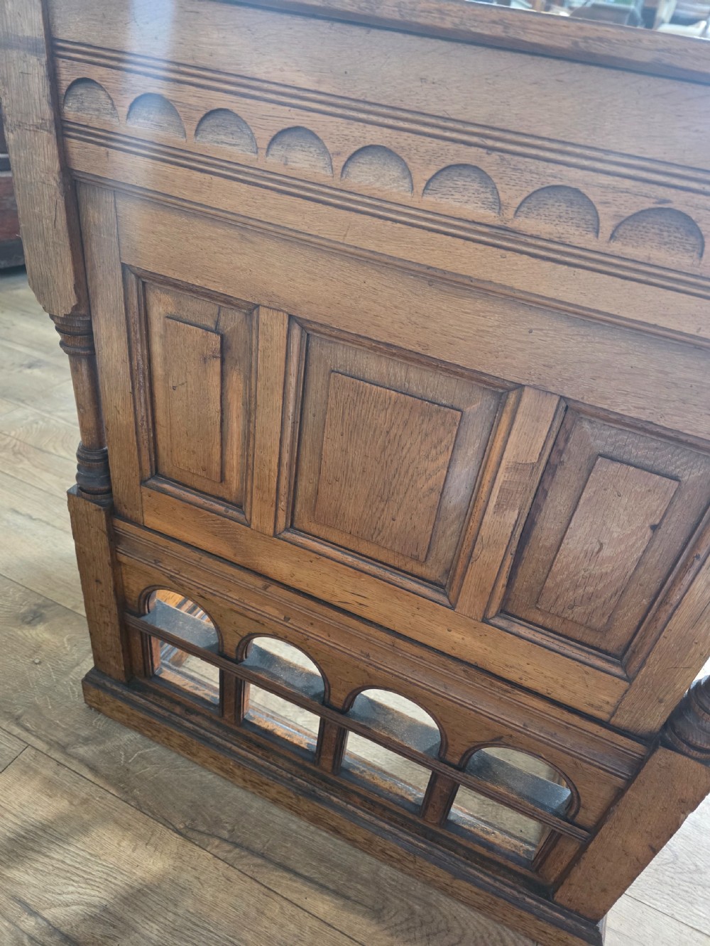 A late Victorian oak clerks desk with an inset green leather writing top, turned legs, and an arcaded lower framework. View XIV
