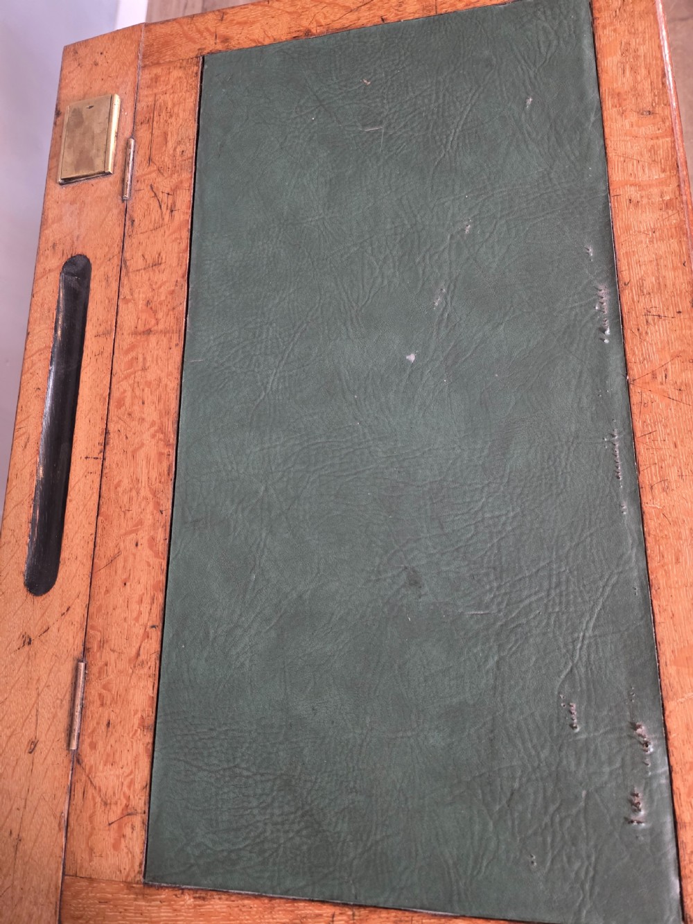 A late Victorian oak clerks desk with an inset green leather writing top, turned legs, and an arcaded lower framework. View XVIII