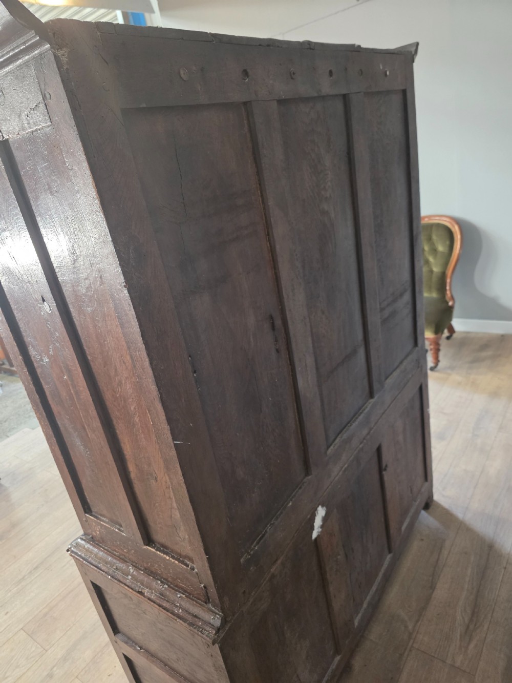 A dark oak two-tier antique cupboard with arched panel double doors above a base with recessed panels and two drawers. View XIII