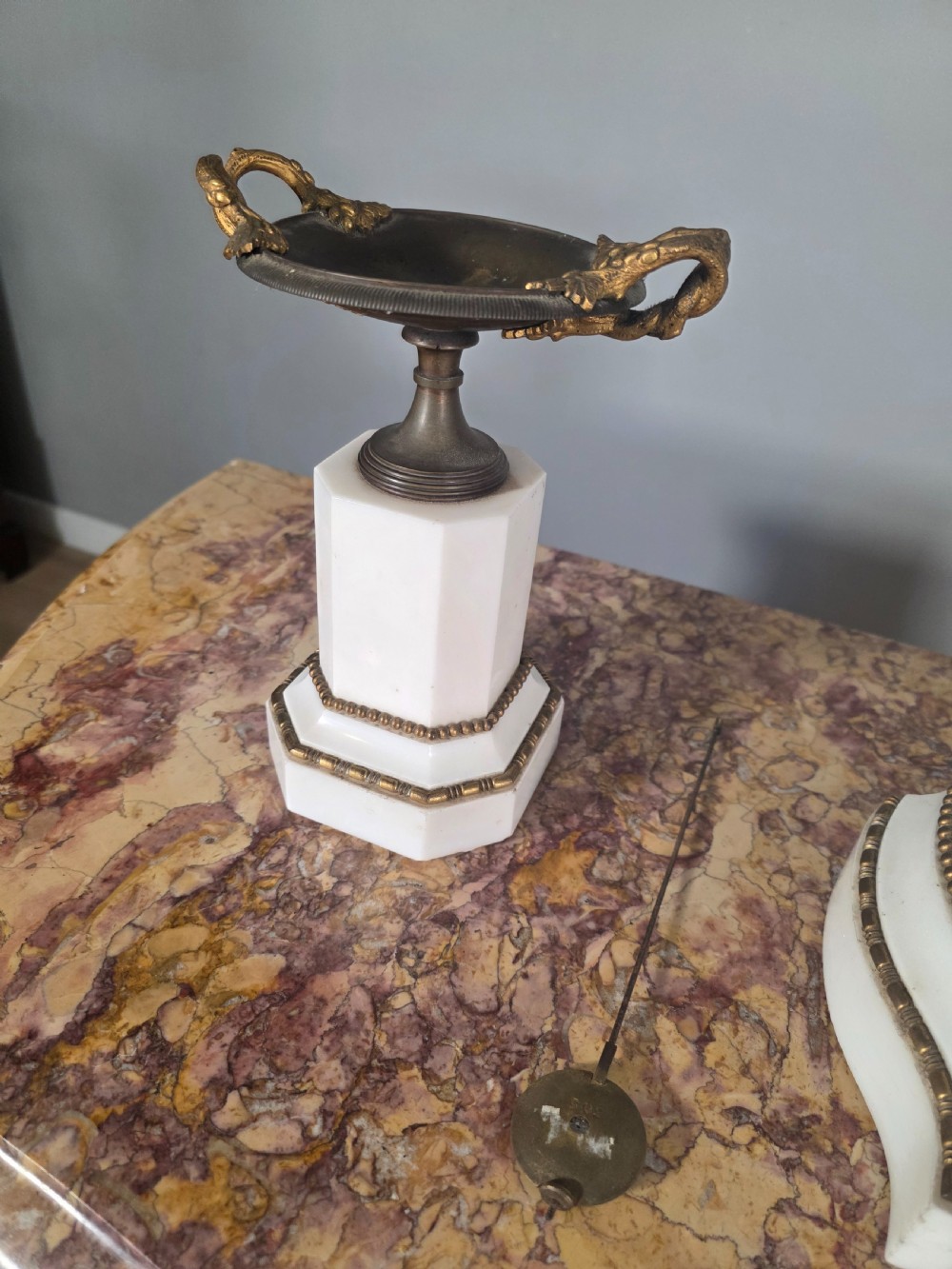 A late 19th-century French white marble mantel clock set featuring a patinated bronze seated female figure surmount, flanked by two matching marble tazze. View IV