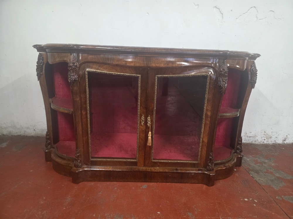 A Victorian rosewood credenza featuring central glazed double doors flanked by open curved side shelves with crimson fabric lining. View III