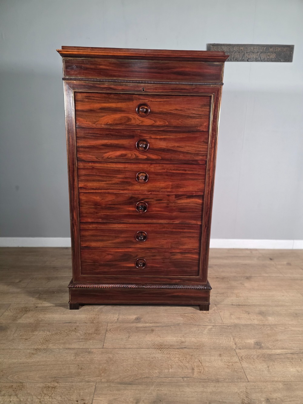 A tall 19th-century French rosewood chest featuring six drawers decorated with brass inlay stringing and turned wooden handles. View II