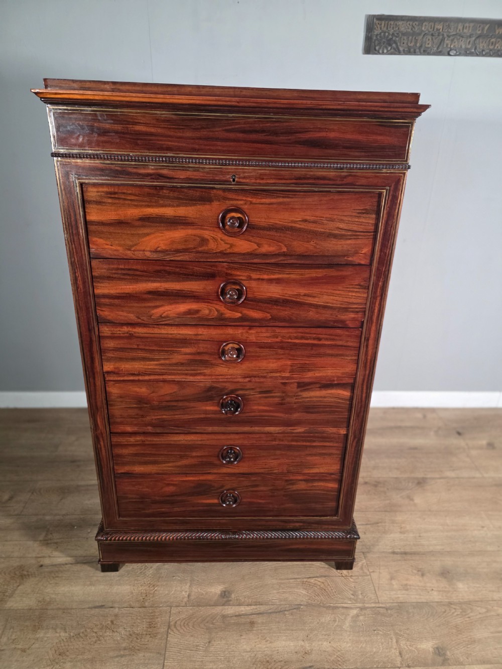 A tall 19th-century French rosewood chest featuring six drawers decorated with brass inlay stringing and turned wooden handles. View III