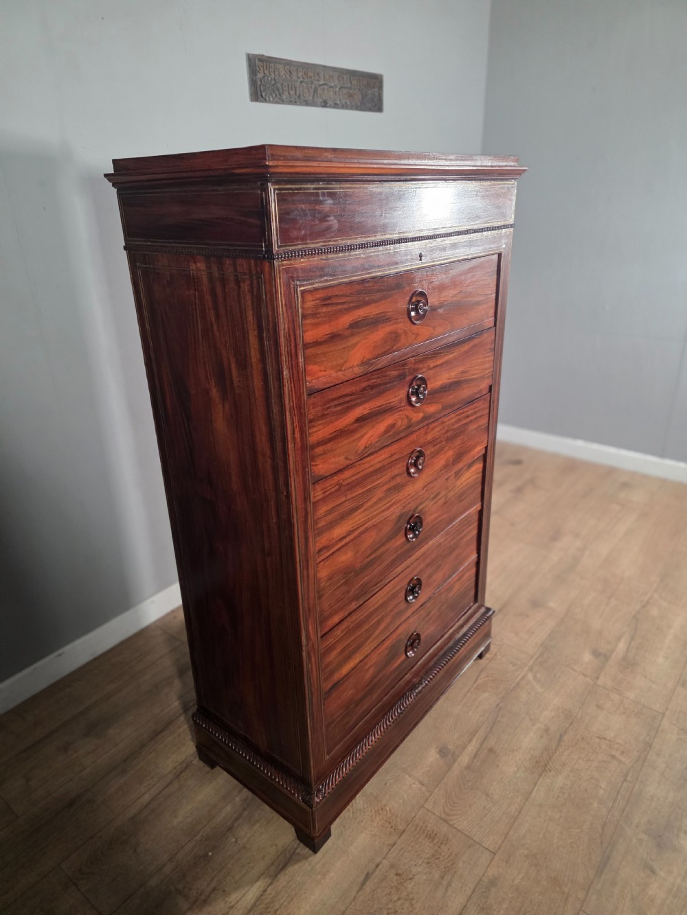 A tall 19th-century French rosewood chest featuring six drawers decorated with brass inlay stringing and turned wooden handles. View V