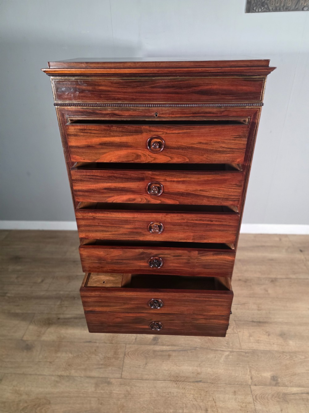 A tall 19th-century French rosewood chest featuring six drawers decorated with brass inlay stringing and turned wooden handles. View VII
