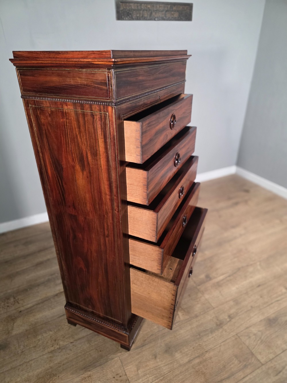A tall 19th-century French rosewood chest featuring six drawers decorated with brass inlay stringing and turned wooden handles. View VIII