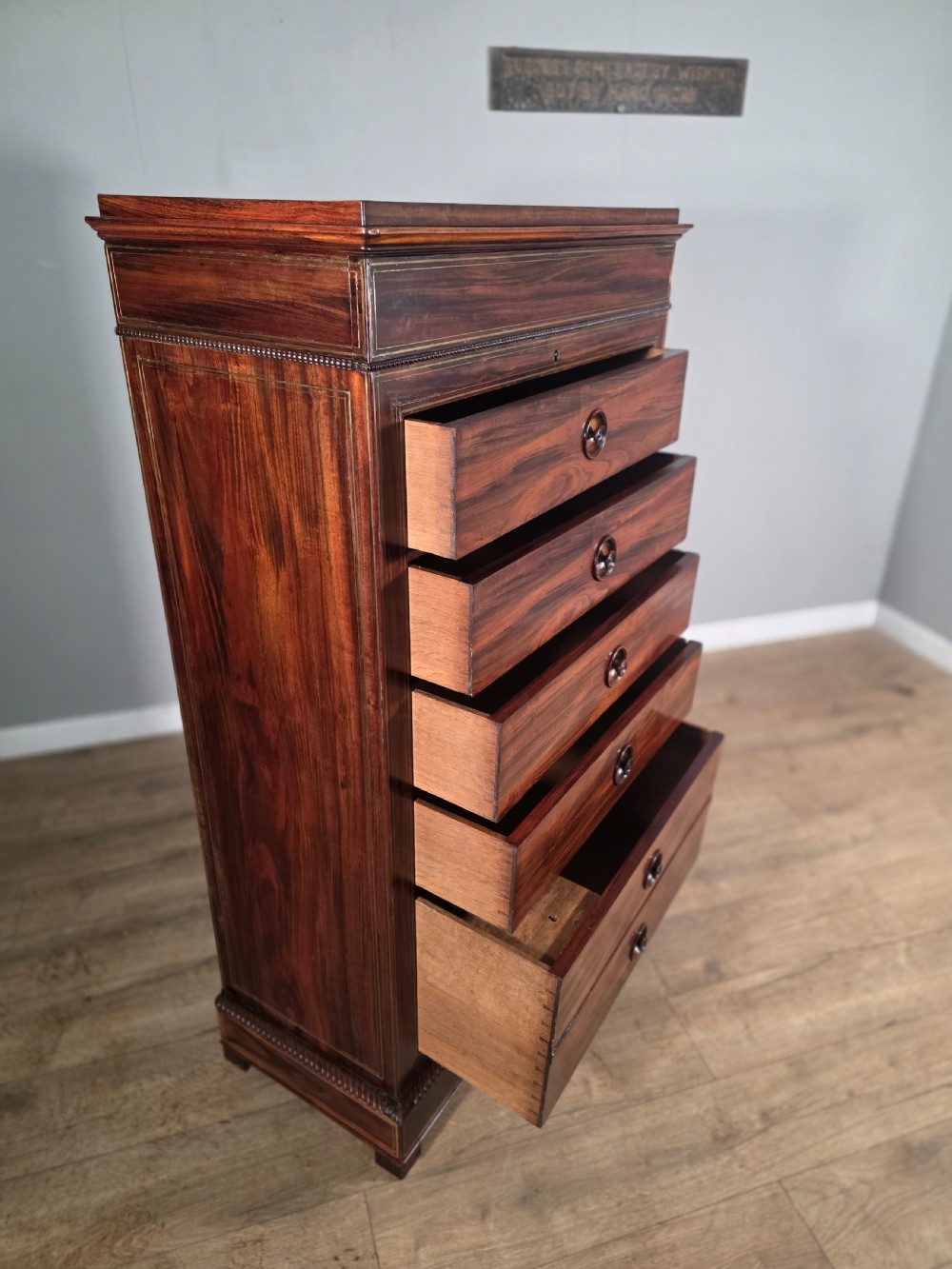 A tall 19th-century French rosewood chest featuring six drawers decorated with brass inlay stringing and turned wooden handles. View IX