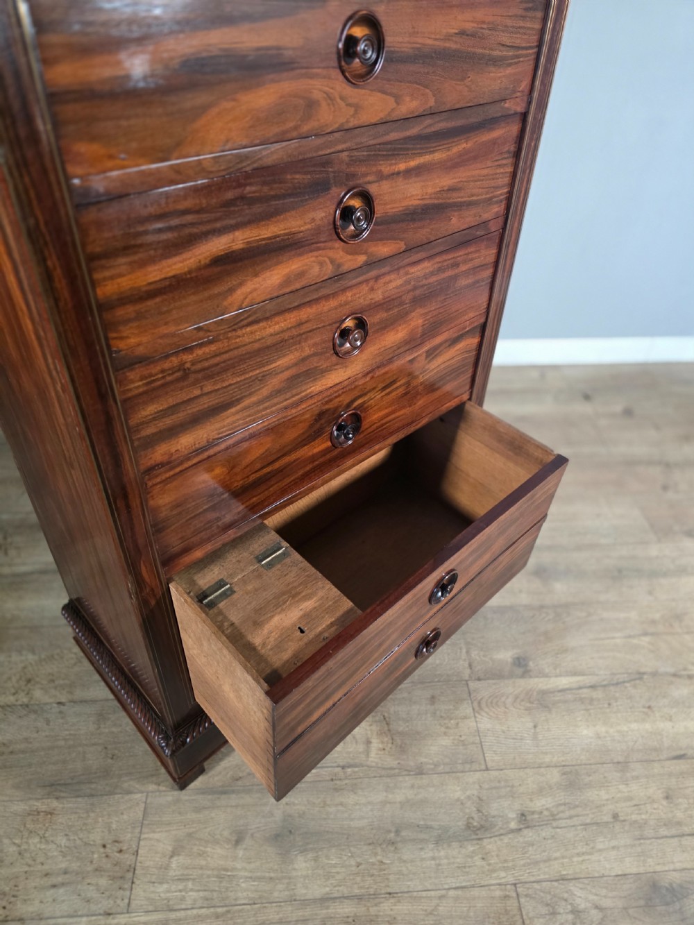 A tall 19th-century French rosewood chest featuring six drawers decorated with brass inlay stringing and turned wooden handles. View X