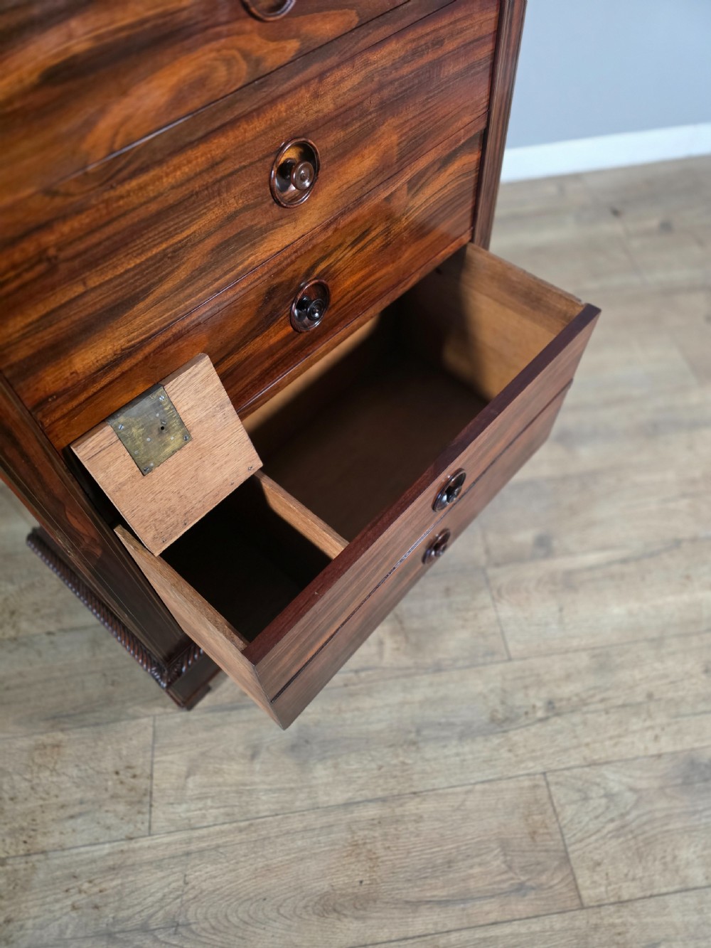 A tall 19th-century French rosewood chest featuring six drawers decorated with brass inlay stringing and turned wooden handles. View XI