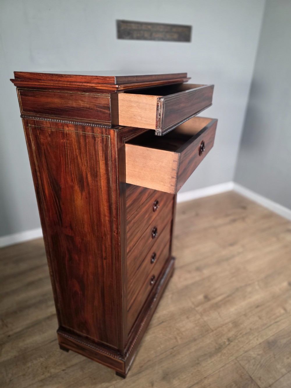 A tall 19th-century French rosewood chest featuring six drawers decorated with brass inlay stringing and turned wooden handles. View XII