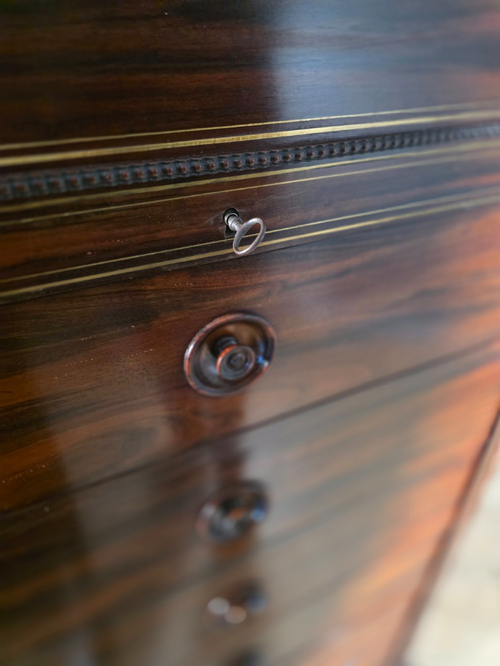 A tall 19th-century French rosewood chest featuring six drawers decorated with brass inlay stringing and turned wooden handles. View XIV