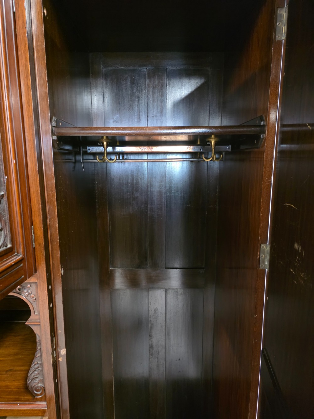 A late Victorian walnut combination wardrobe featuring twin mirrored doors flanking a central section of carved cupboards, an open shelf niche, and five burr walnut drawers. View XI