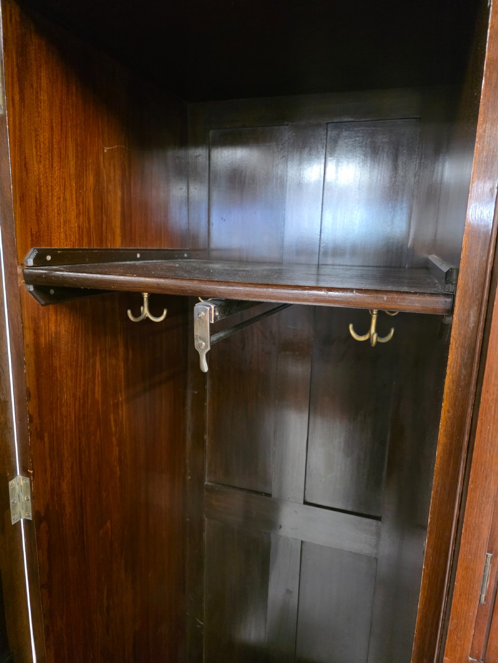 A late Victorian walnut combination wardrobe featuring twin mirrored doors flanking a central section of carved cupboards, an open shelf niche, and five burr walnut drawers. View XIII