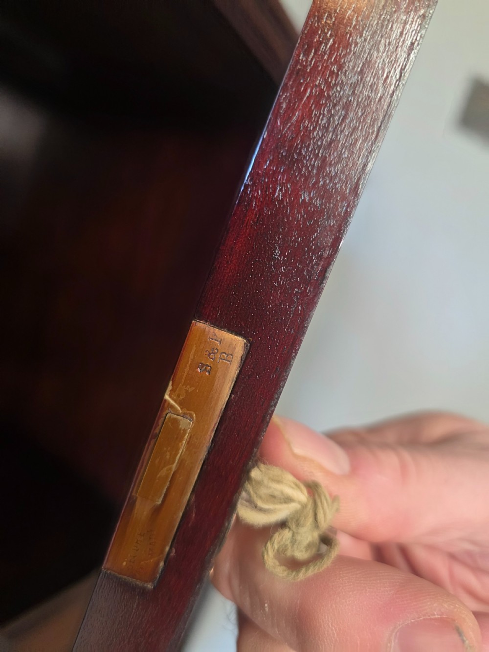 An antique dark mahogany Arts and Crafts display bookcase featuring a top galleried balustrade, open side shelves with pierced cut-outs, two glazed cabinet doors, and two middle drawers. View IX