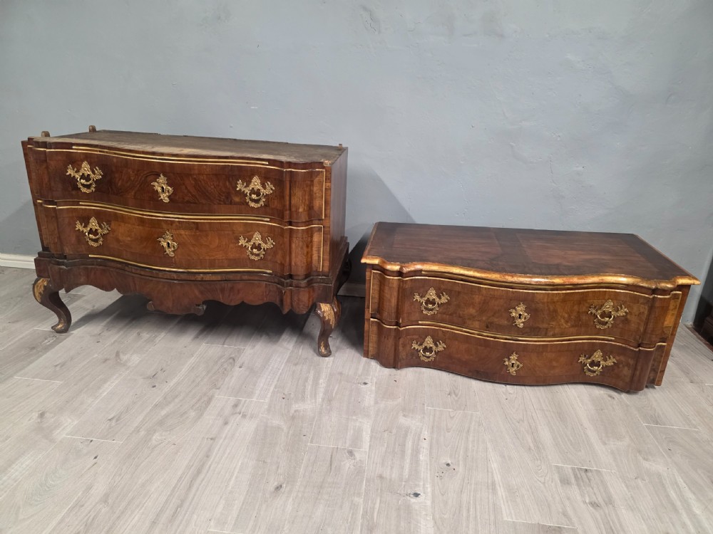 An 18th-century walnut chest of drawers featuring a serpentine front, four drawers, ornate brass handles, and short cabriole legs. View XII
