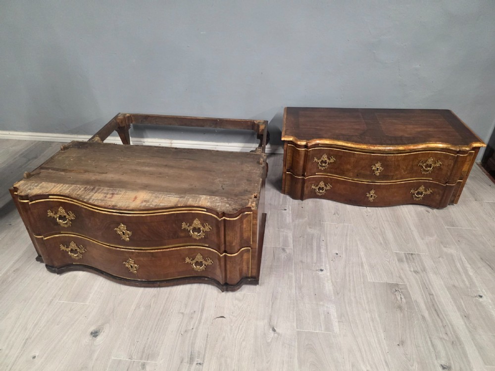 An 18th-century walnut chest of drawers featuring a serpentine front, four drawers, ornate brass handles, and short cabriole legs. View XIV
